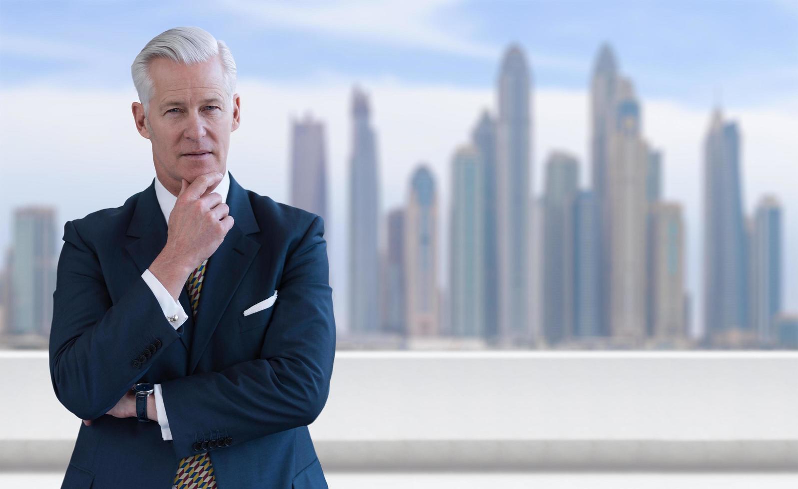 Senior businessman in front of the big city photo