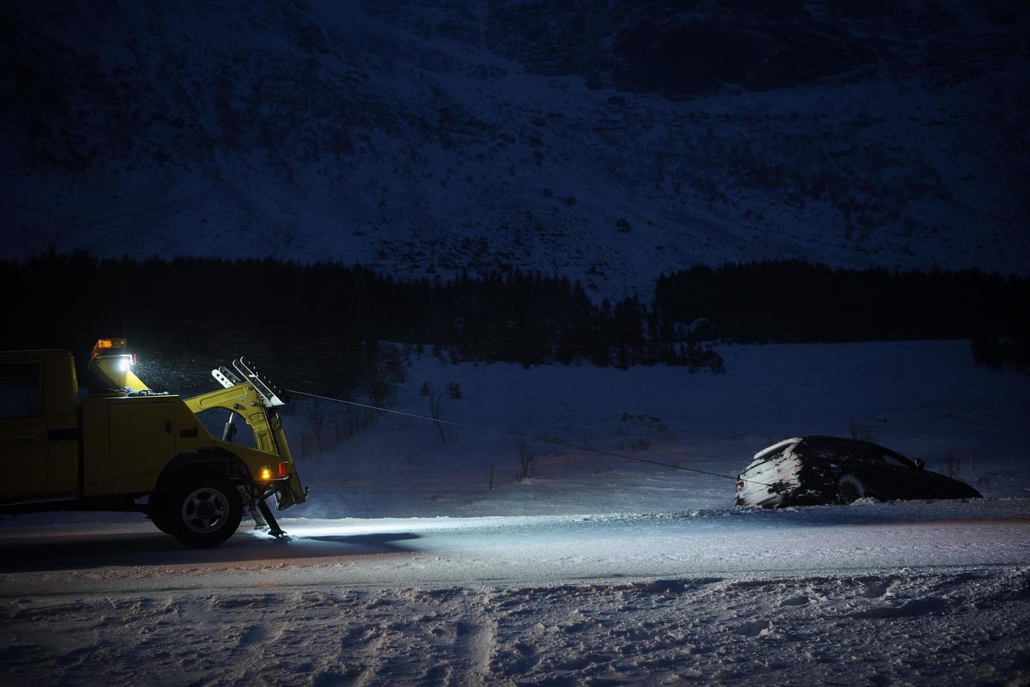 Car being towed after accident in snow storm photo