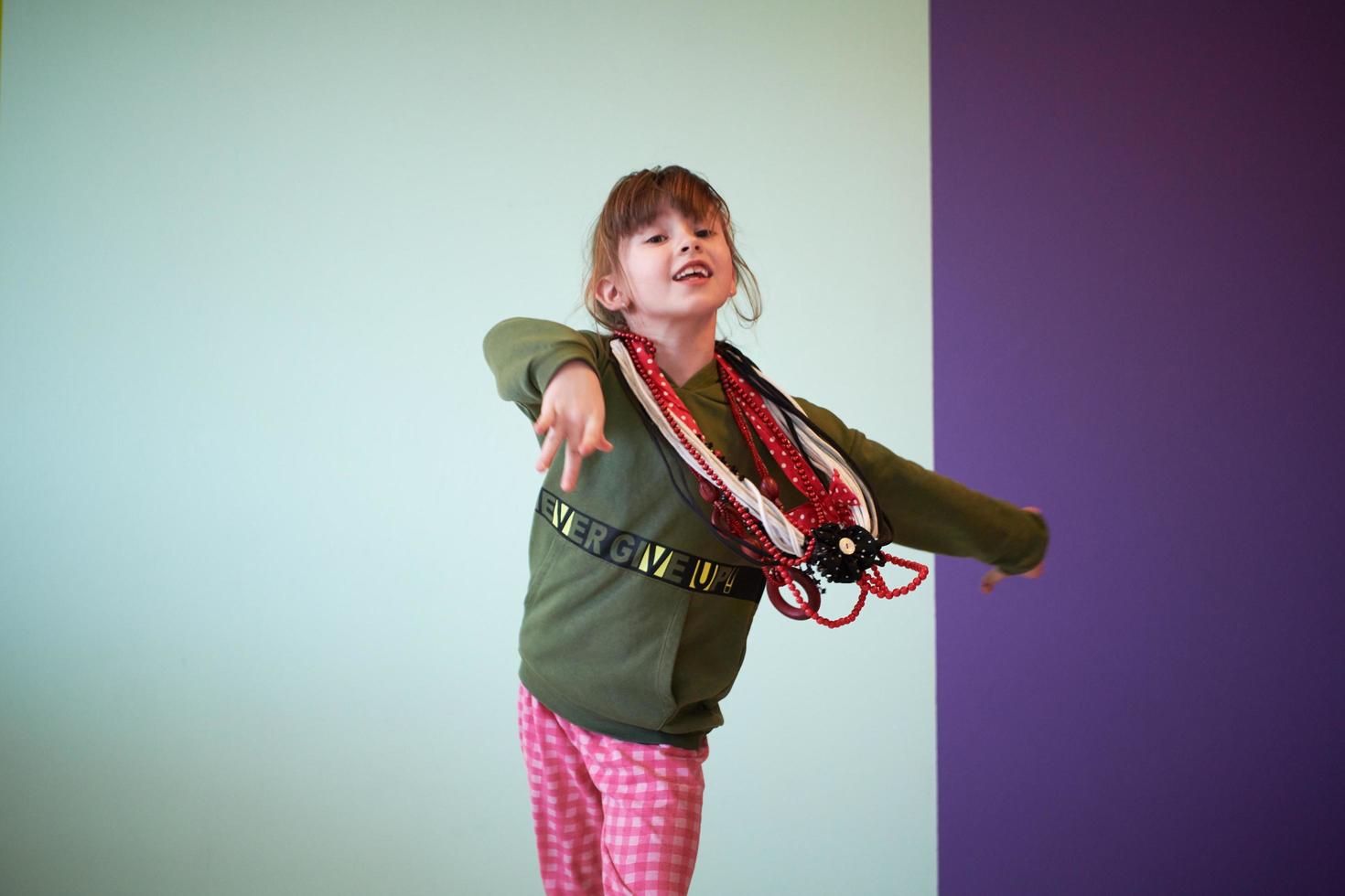 girl having fun and dancing wearing mothers jewelry photo