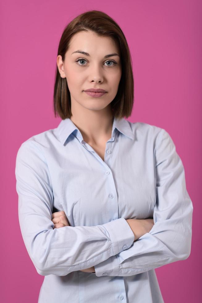 Portrati shot of beautiful blond businesswoman standing with arms crossed at isolated white background. photo