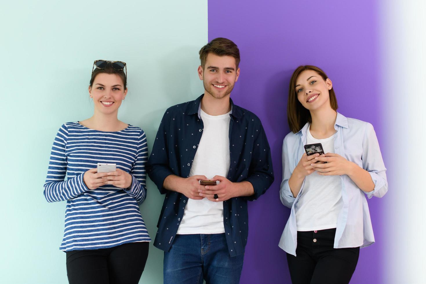 a group of teenagers use mobile devices photo