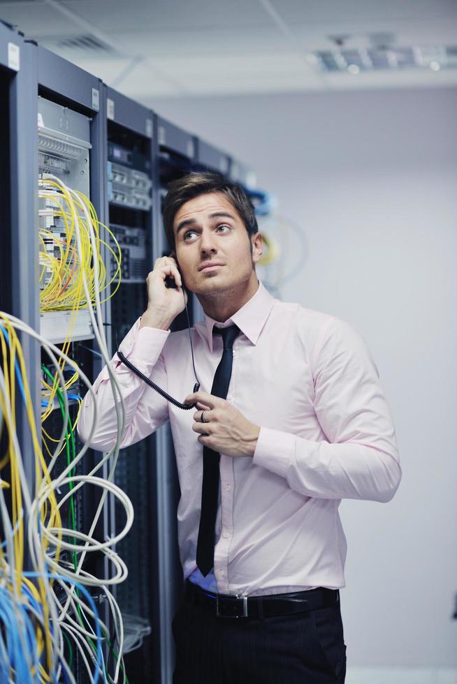 it engeneer talking by phone at network room photo