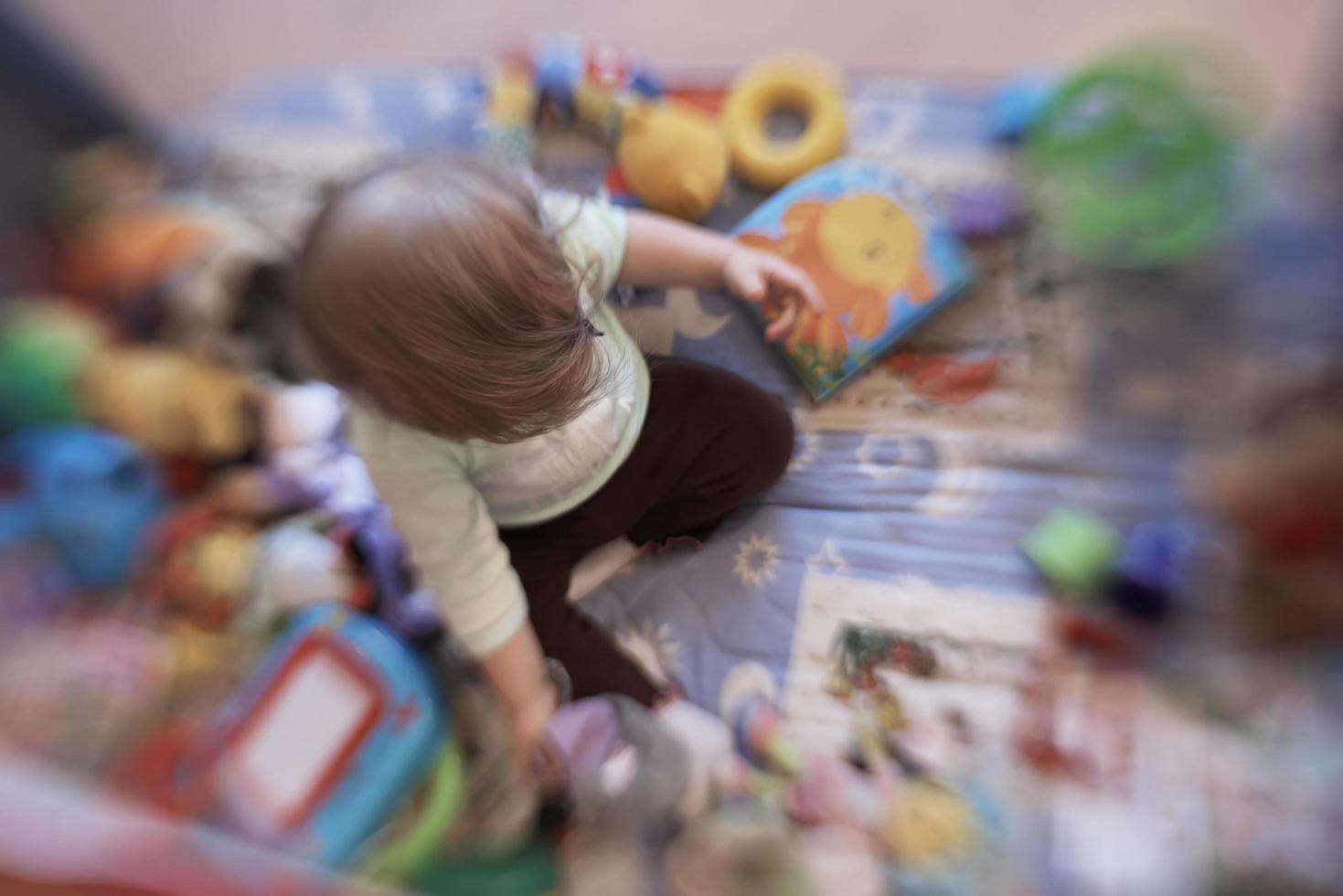 cute  little  baby playing in mobile  bed photo