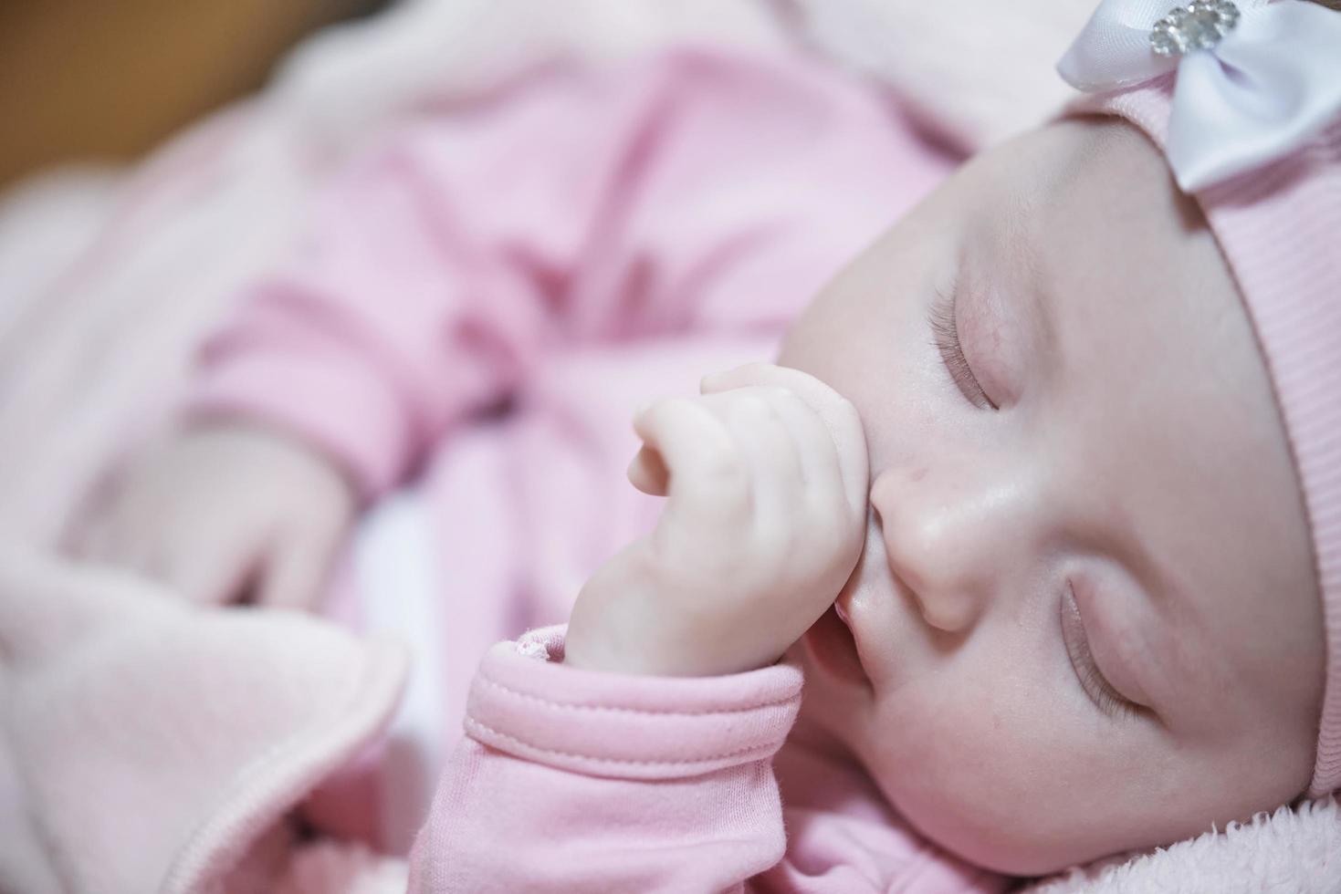 bebé recién nacido durmiendo en casa en la cama foto