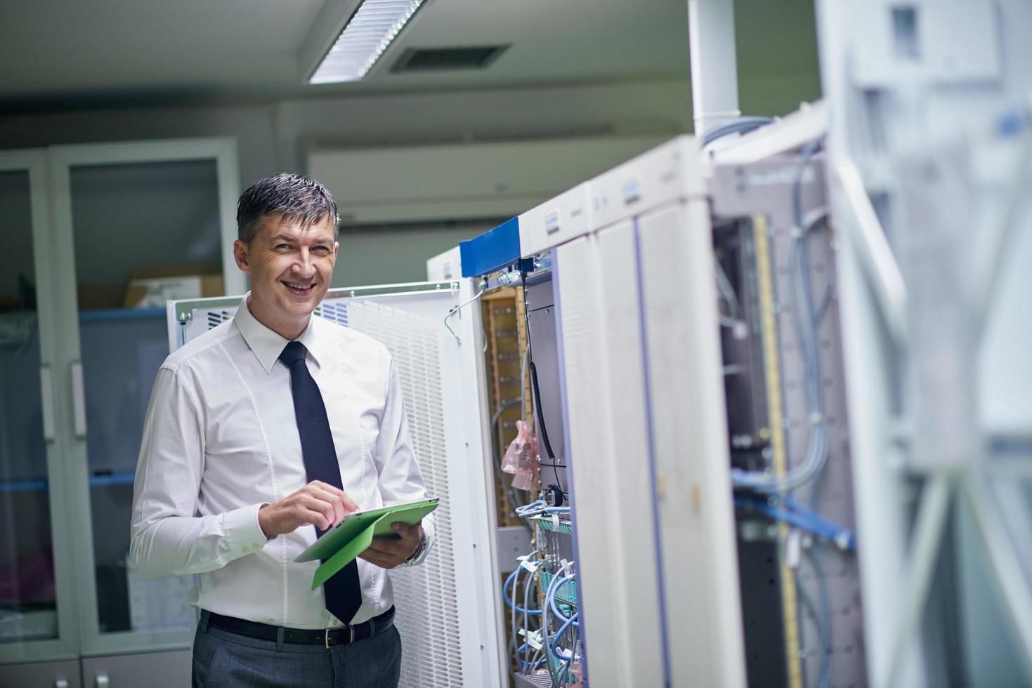 network engineer working in  server room photo