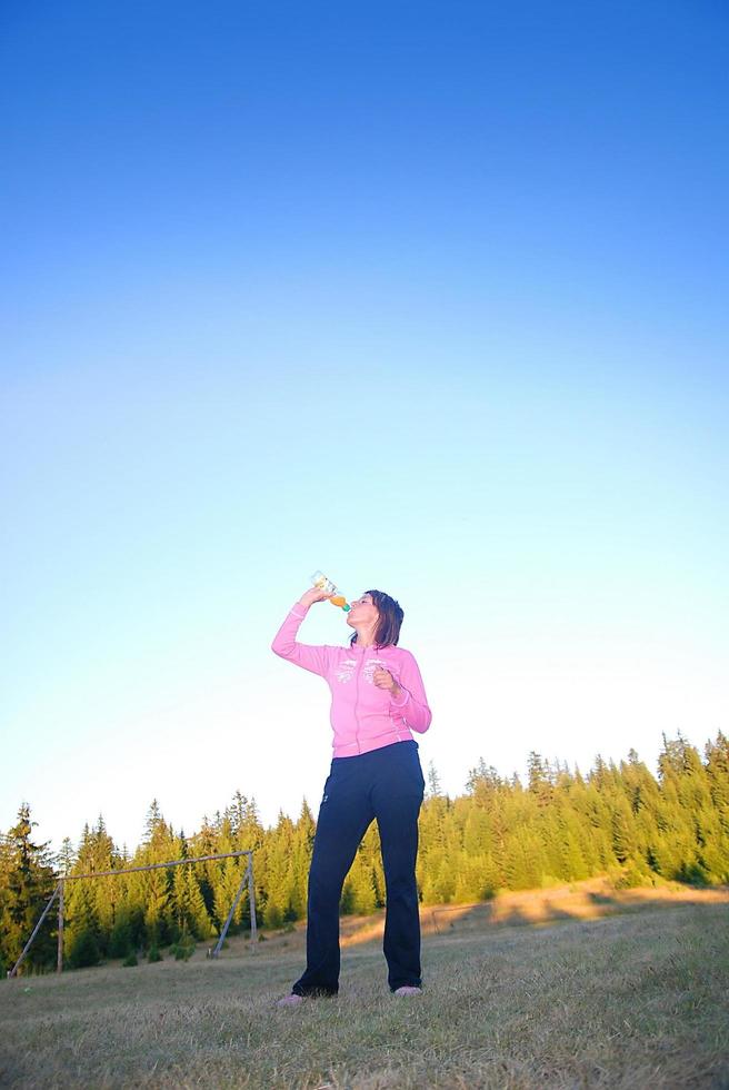 young woman drinking water photo