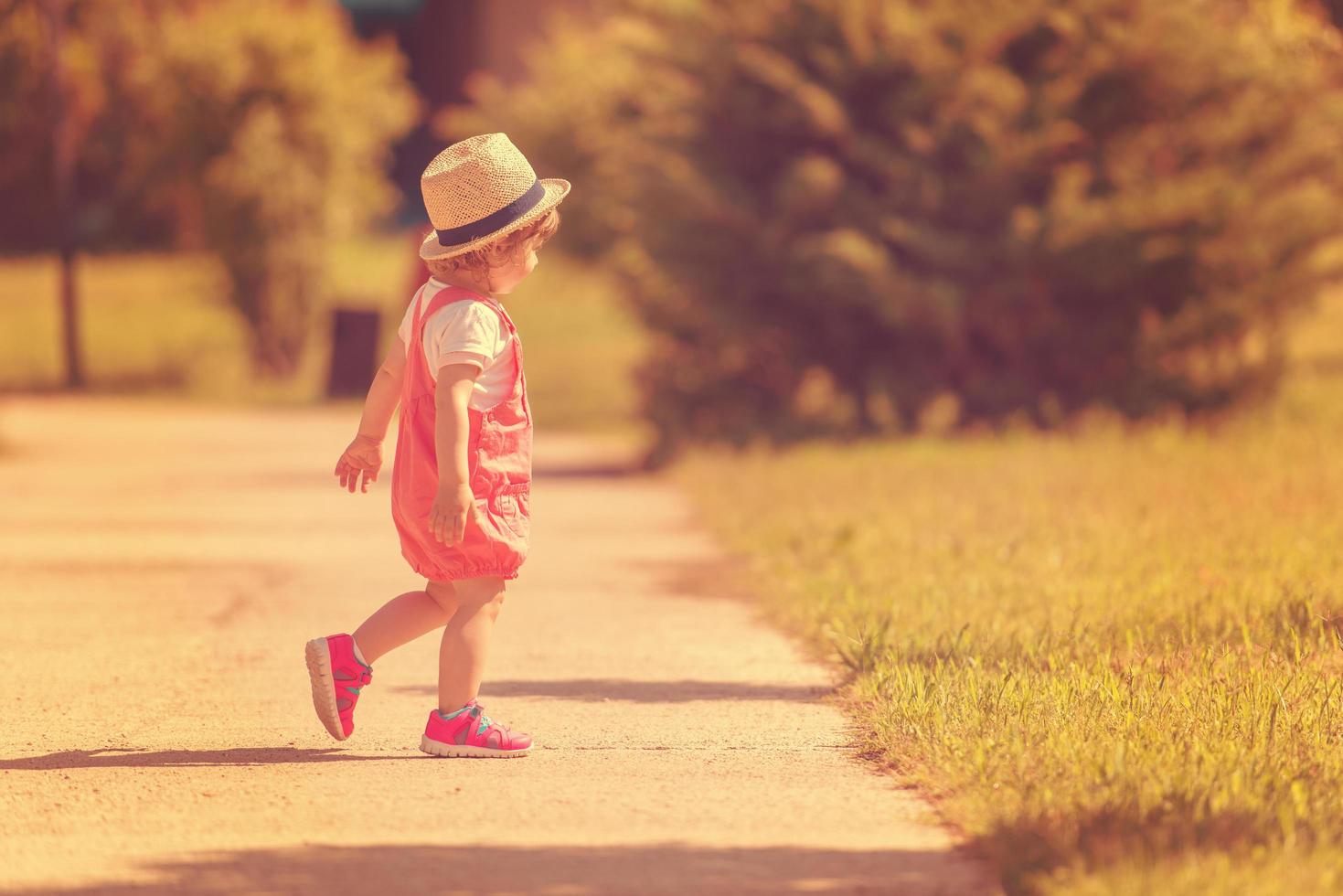 little girl runing in the summer Park photo