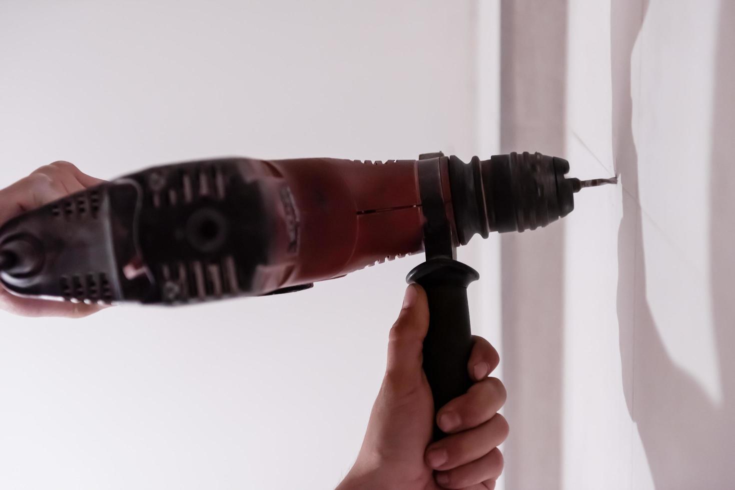 construction worker drilling holes in the bathroom photo