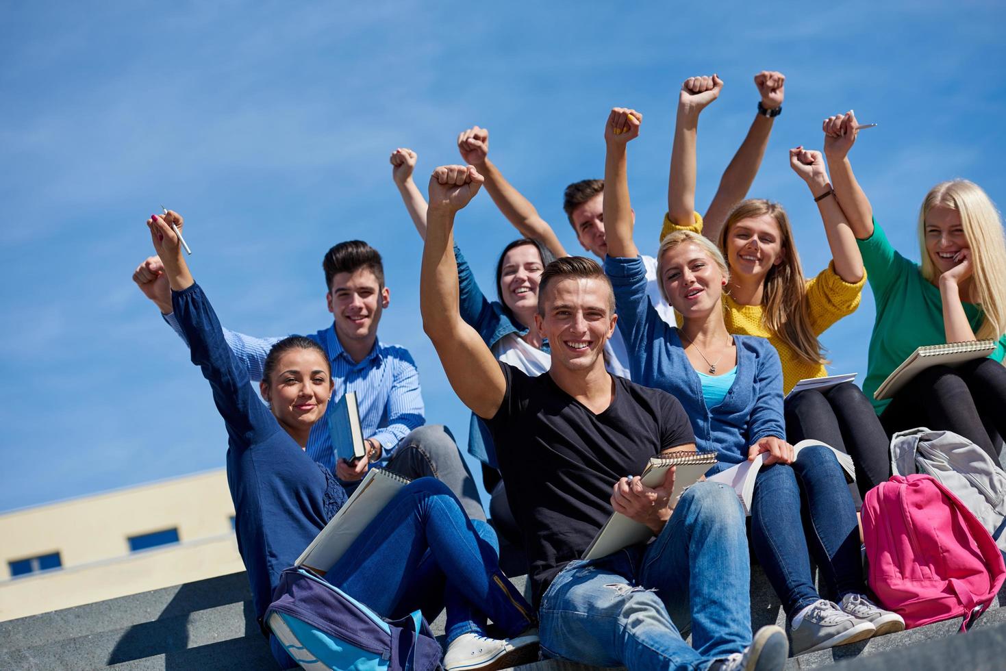 students outside sitting on steps photo