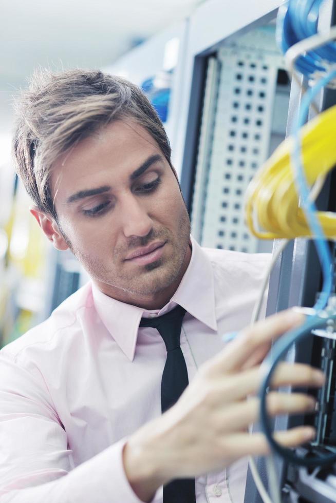 young it engeneer in datacenter server room photo