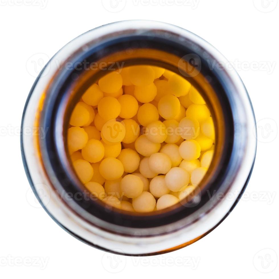 homeopathy sugar balls in glass brown jar photo