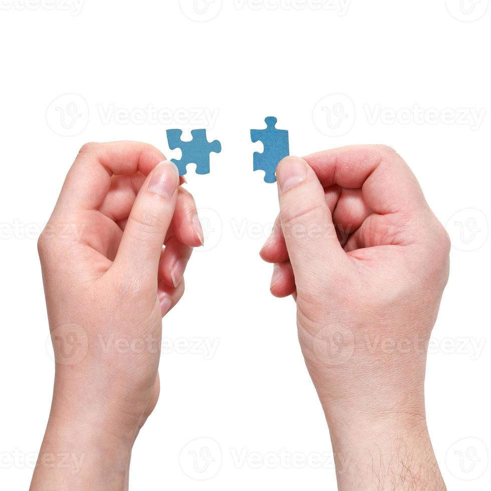 male and female hands with little puzzle pieces photo