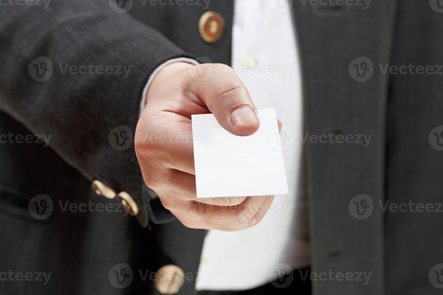 front view of business card in businessman hand photo