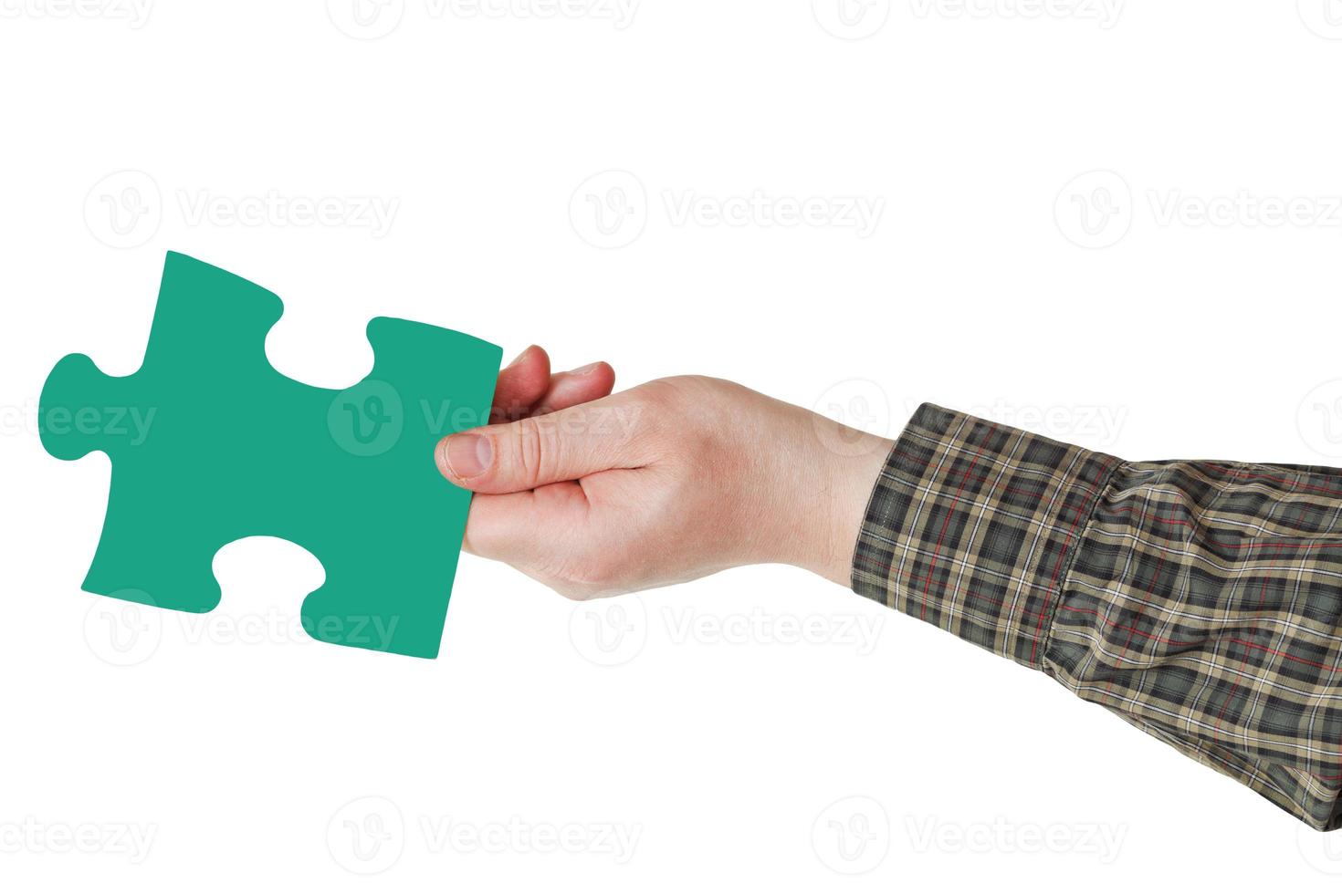 male hand with green puzzle piece photo