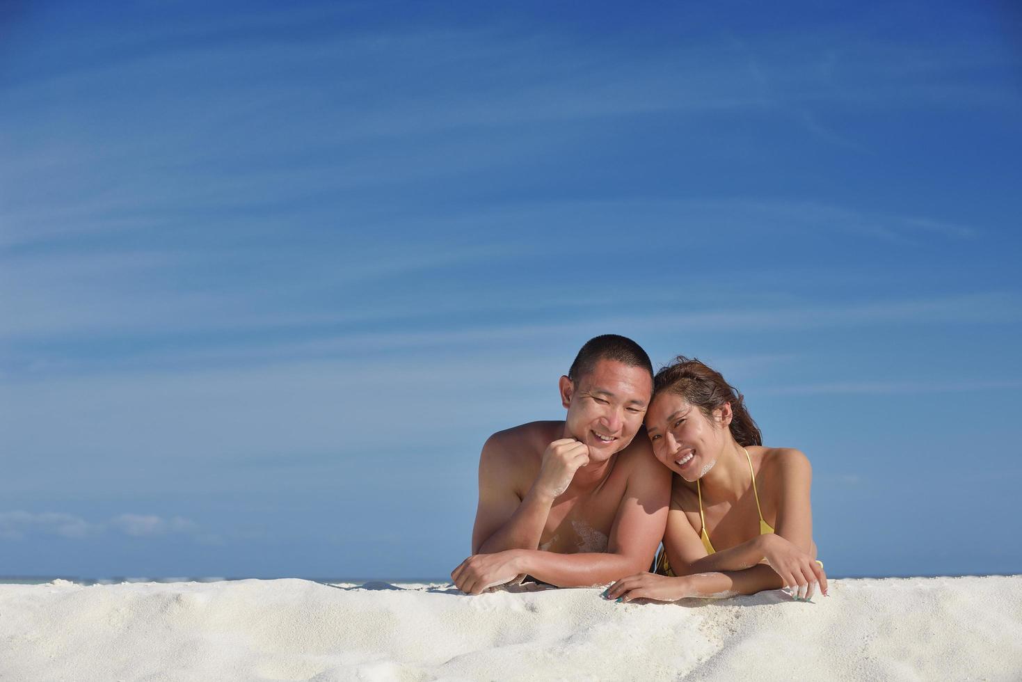 happy young  couple enjoying summer on beach photo