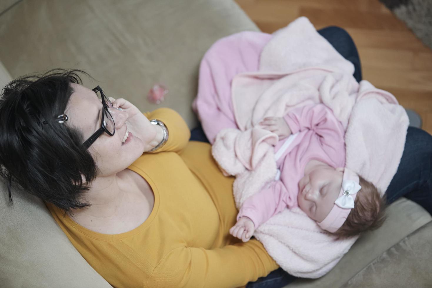 mother is playing with baby at home photo