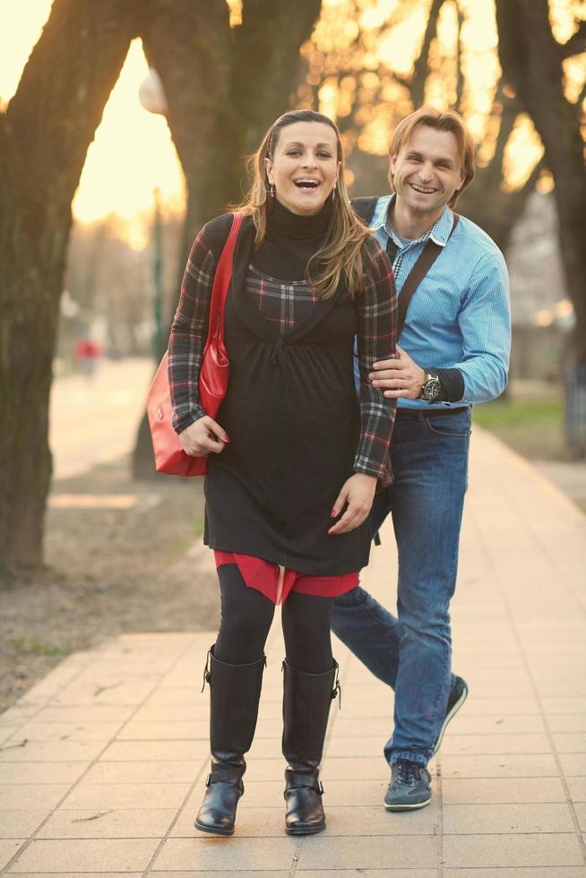 young pregnant couple have fun and relax photo