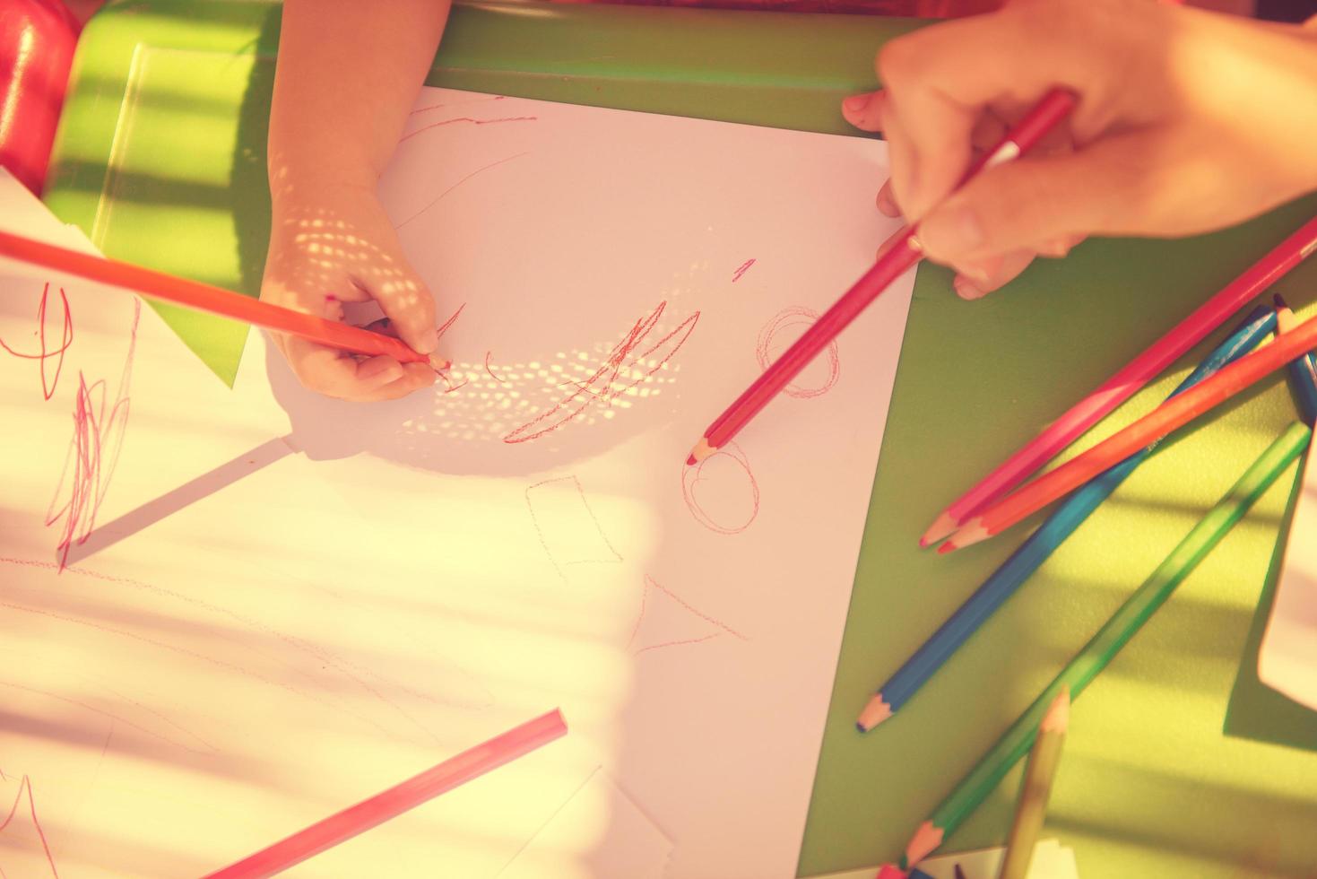 mom and little daughter drawing a colorful pictures photo