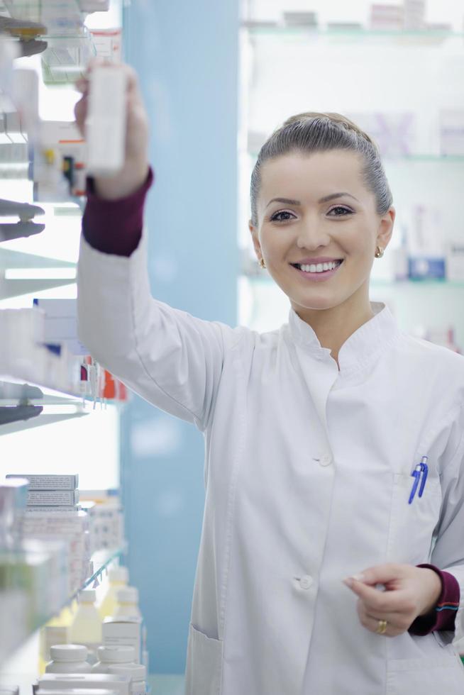 pharmacist chemist woman standing in pharmacy drugstore photo