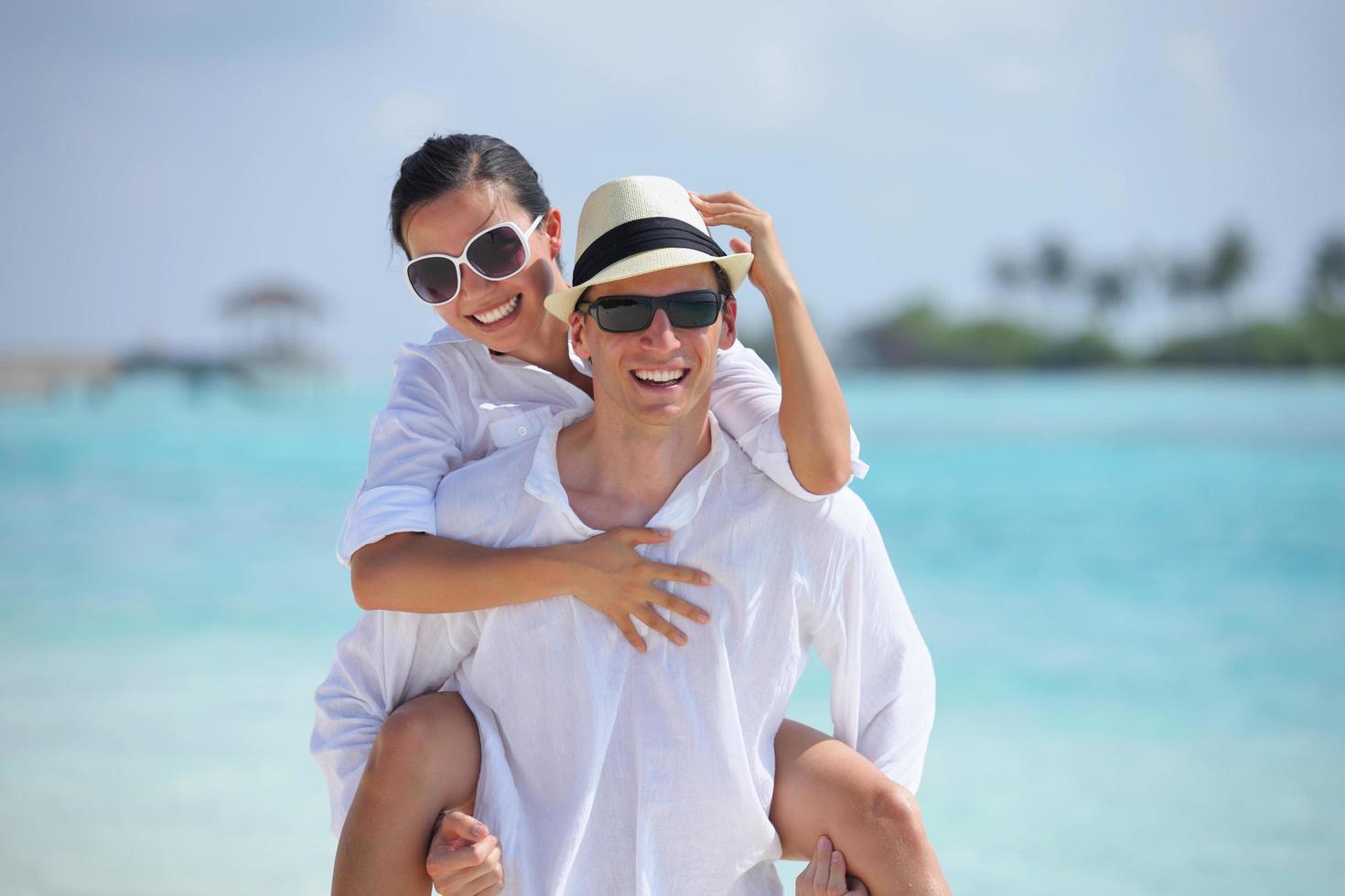happy young couple have fun on beach photo