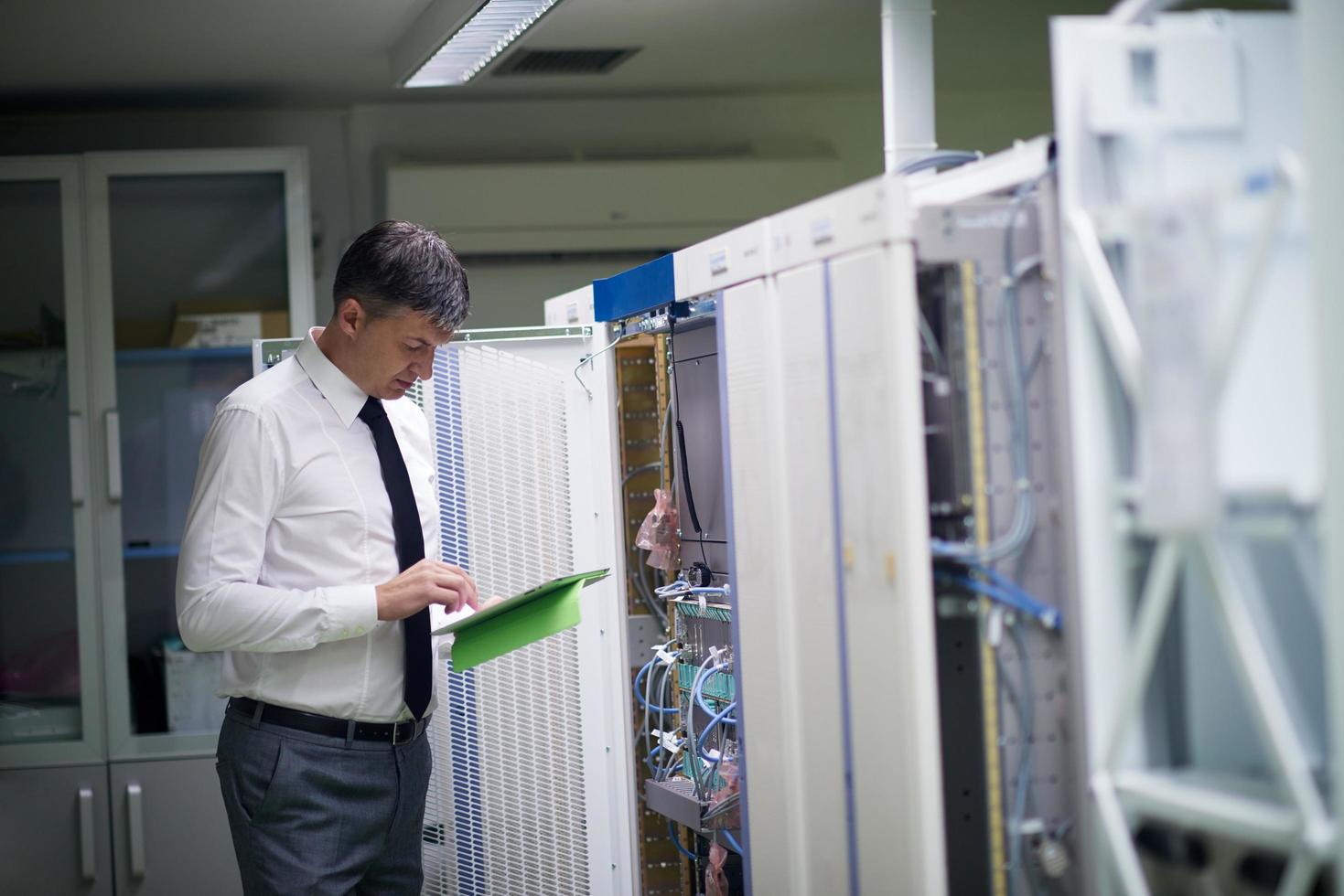 network engineer working in  server room photo