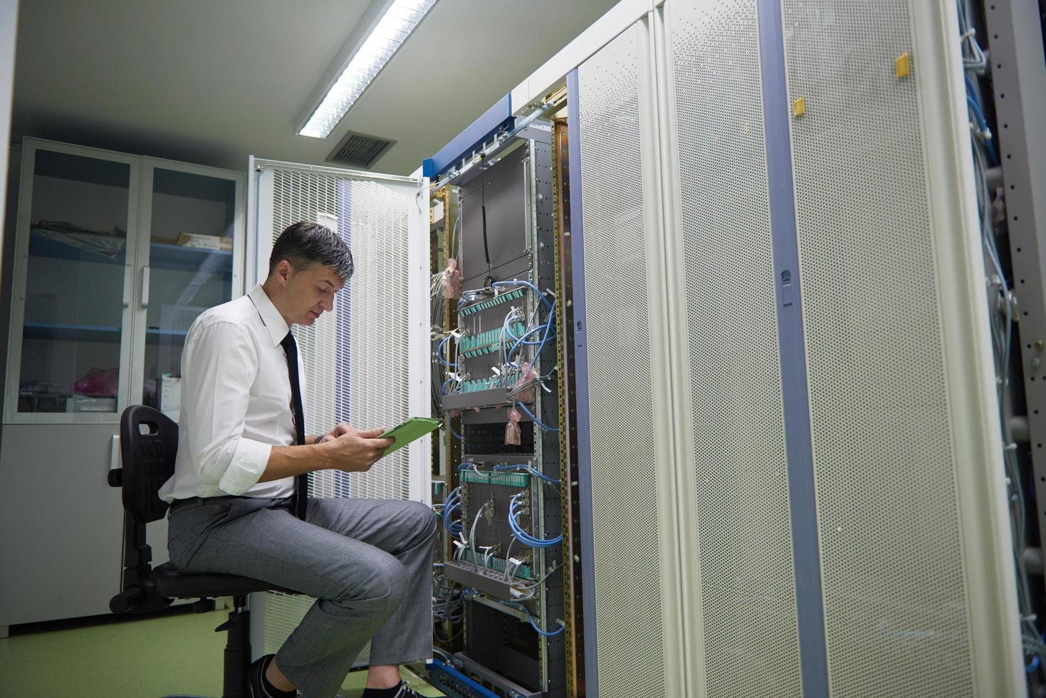 network engineer working in  server room photo