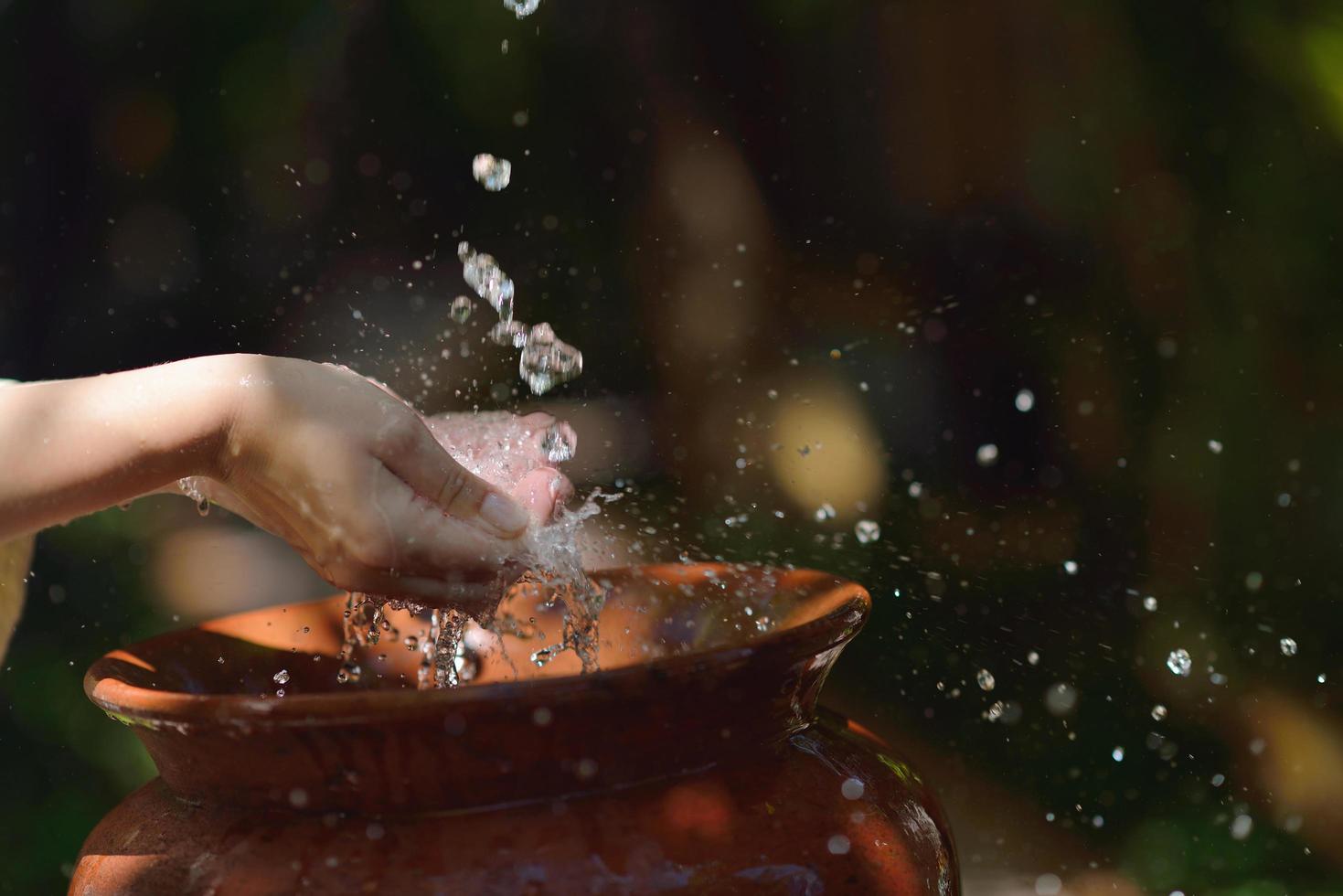 splashing fresh water on woman hands photo