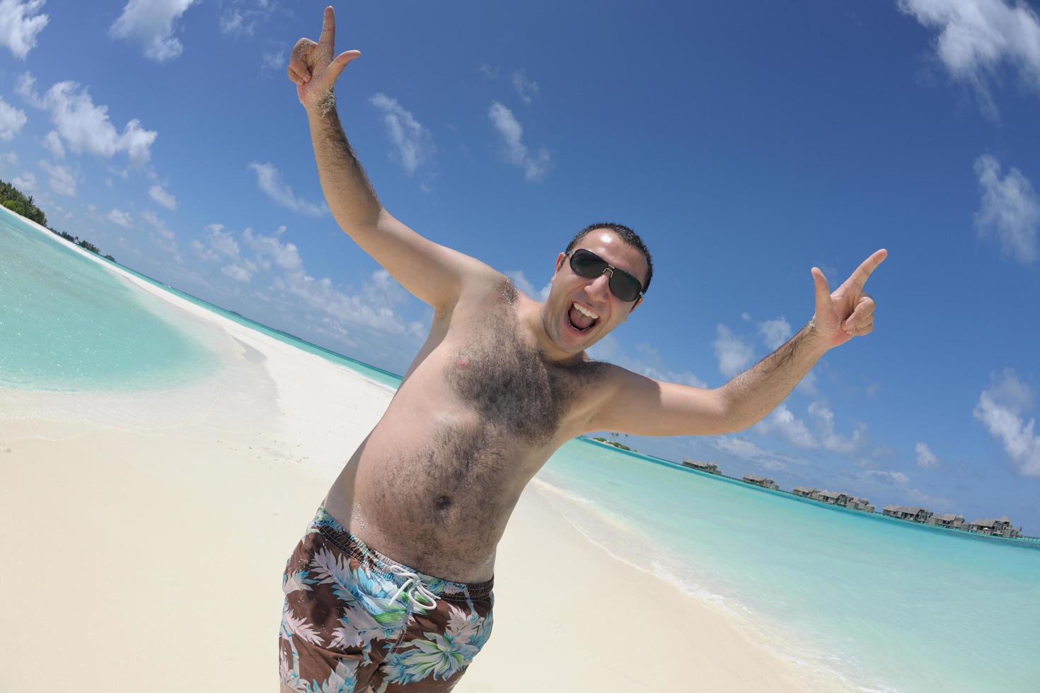 young man have fun and relax on beach photo