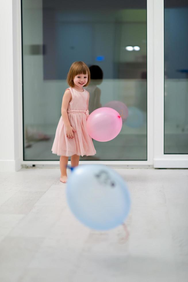 cute little girl playing with balloons photo