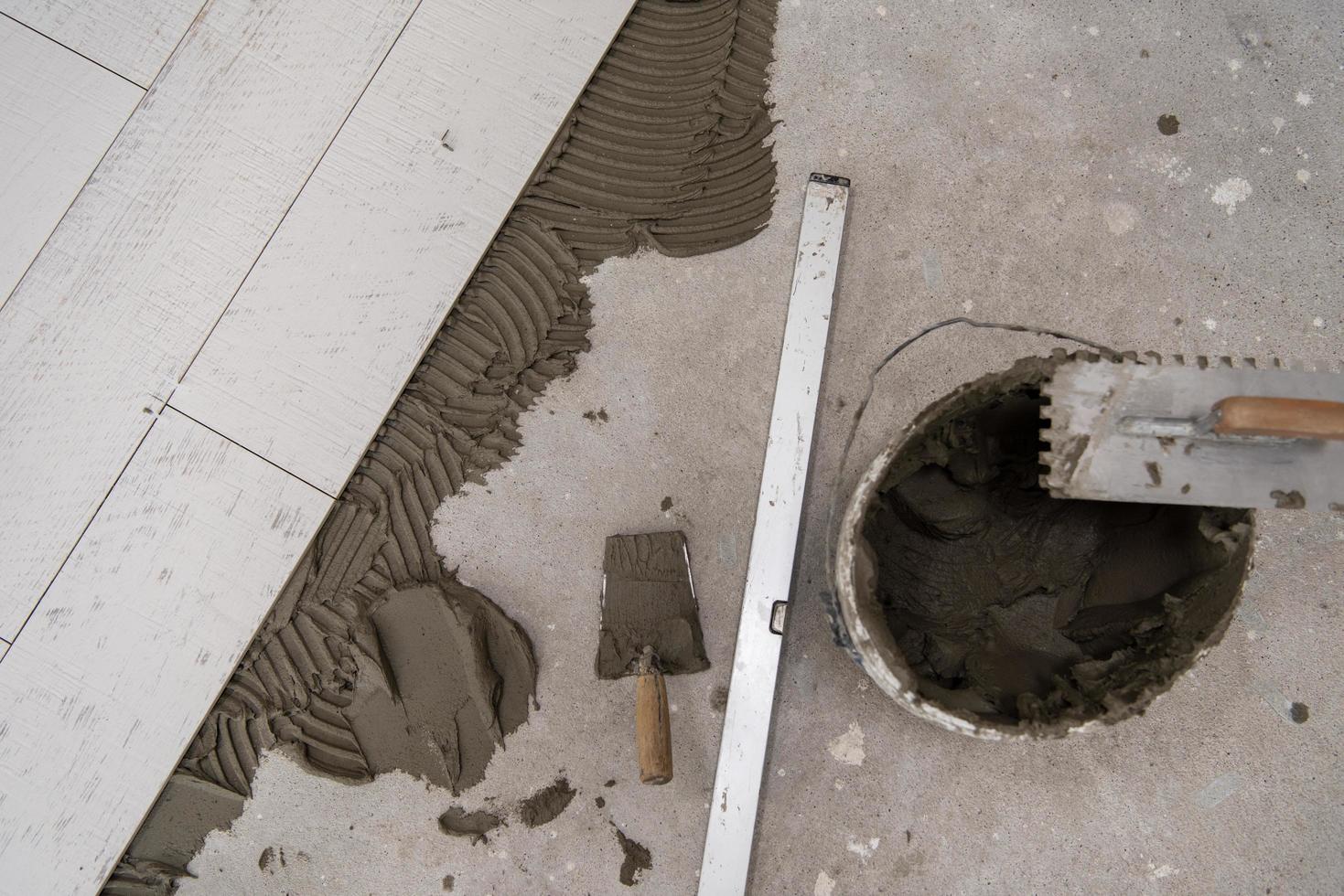 Ceramic wood effect tiles and tools for tiler on the floor photo