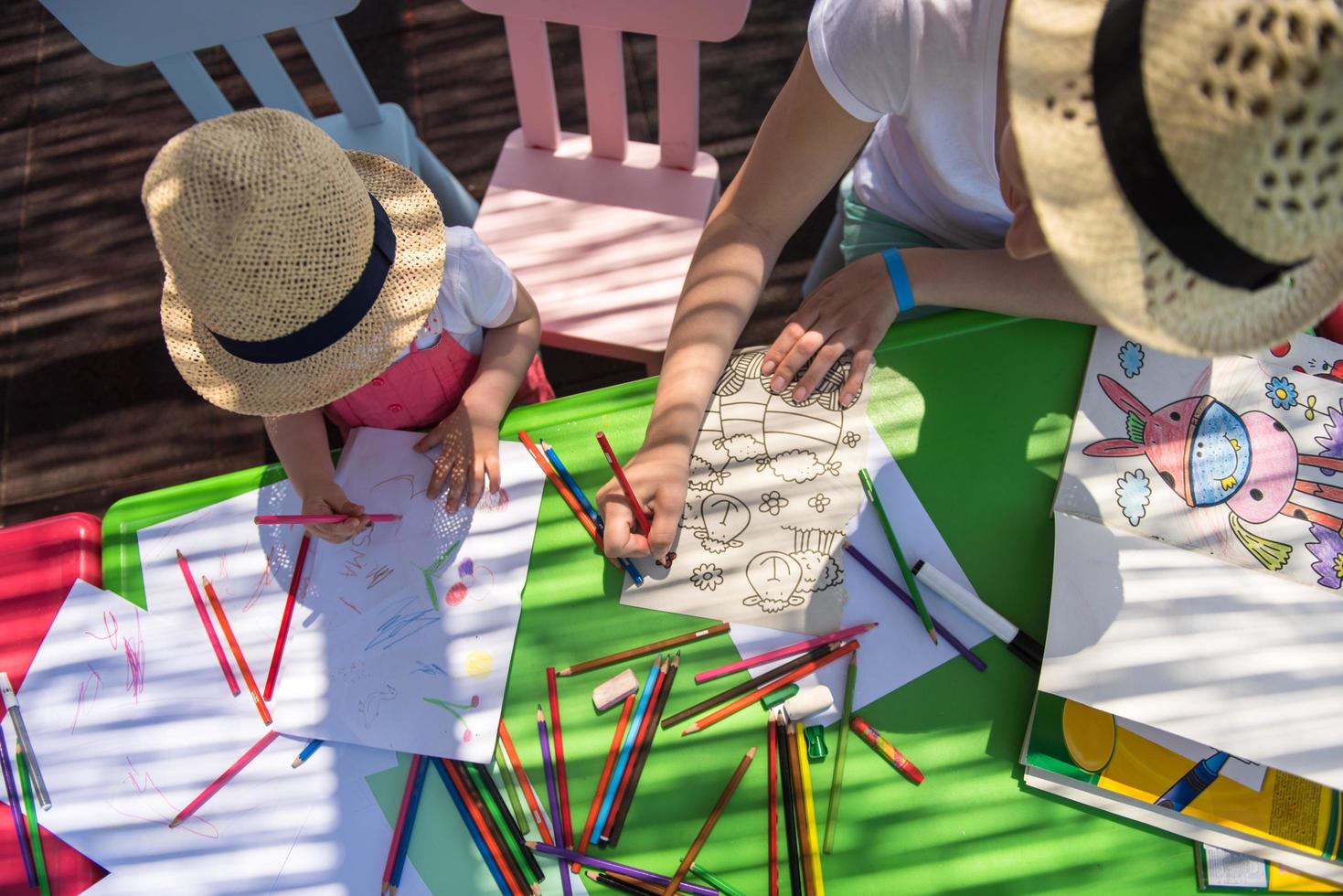 mom and little daughter drawing a colorful pictures photo