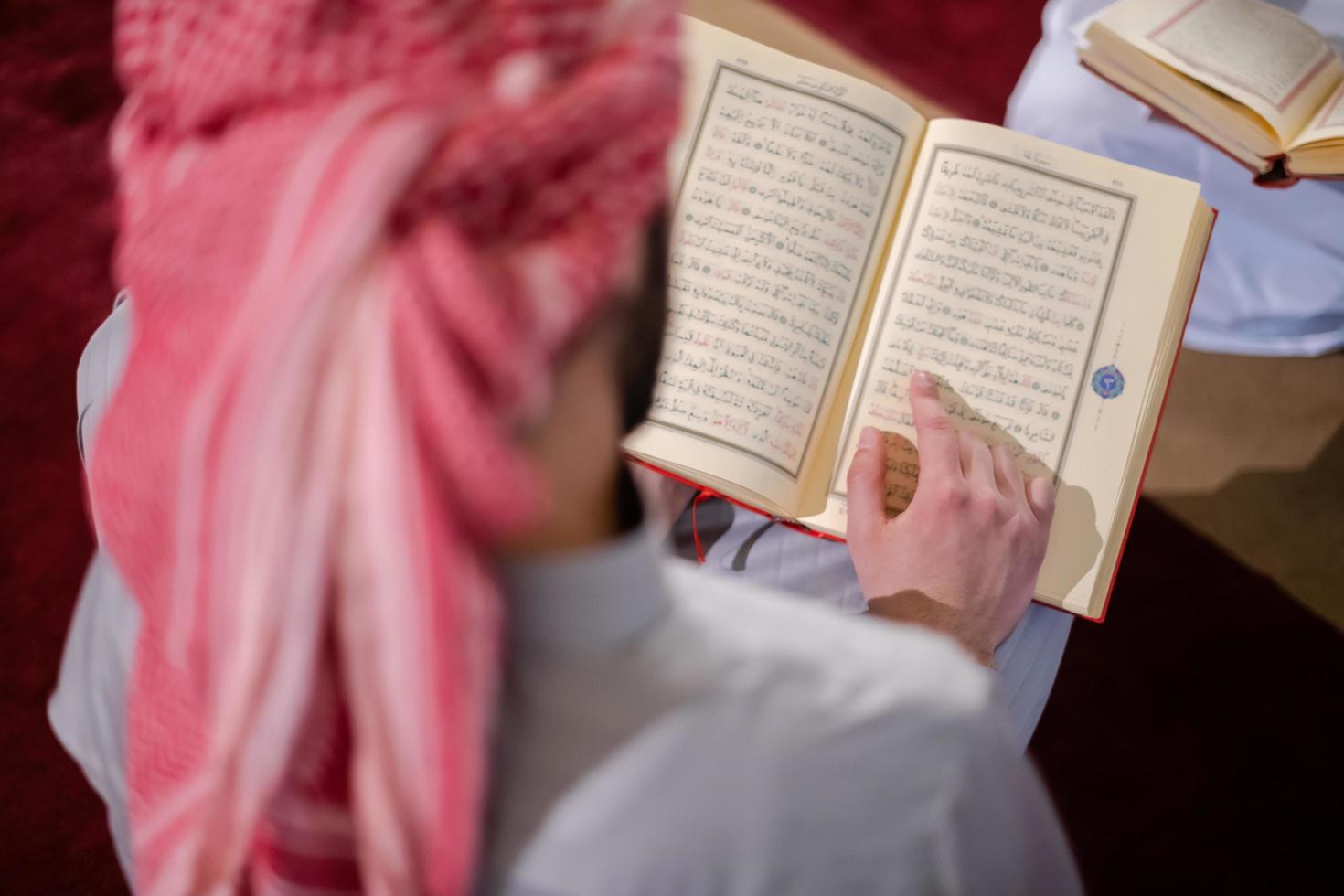 two muslim people in mosque reading quran together concept of islamic education photo