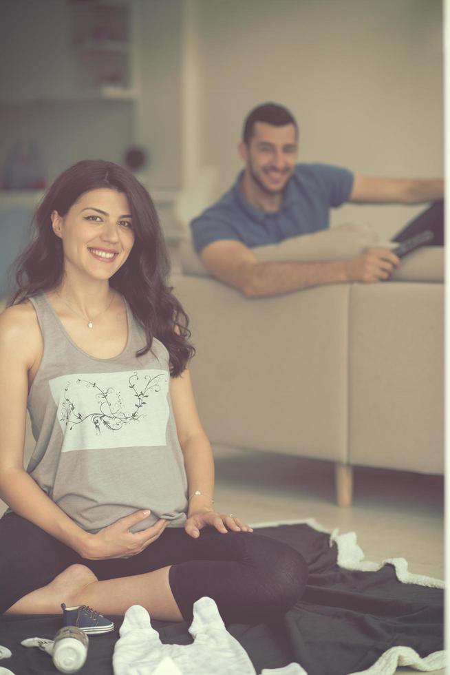 pregnant couple checking a list of things for their unborn baby photo