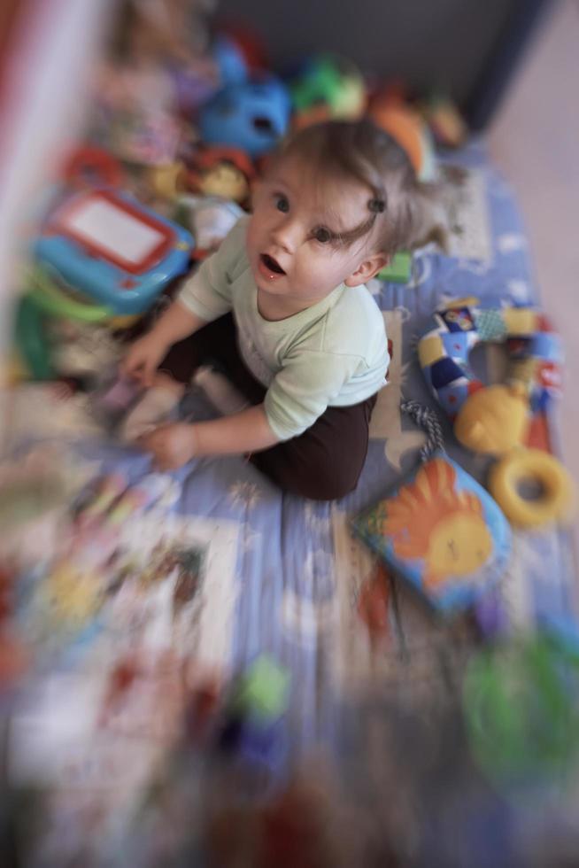 cute  little  baby playing in mobile  bed photo