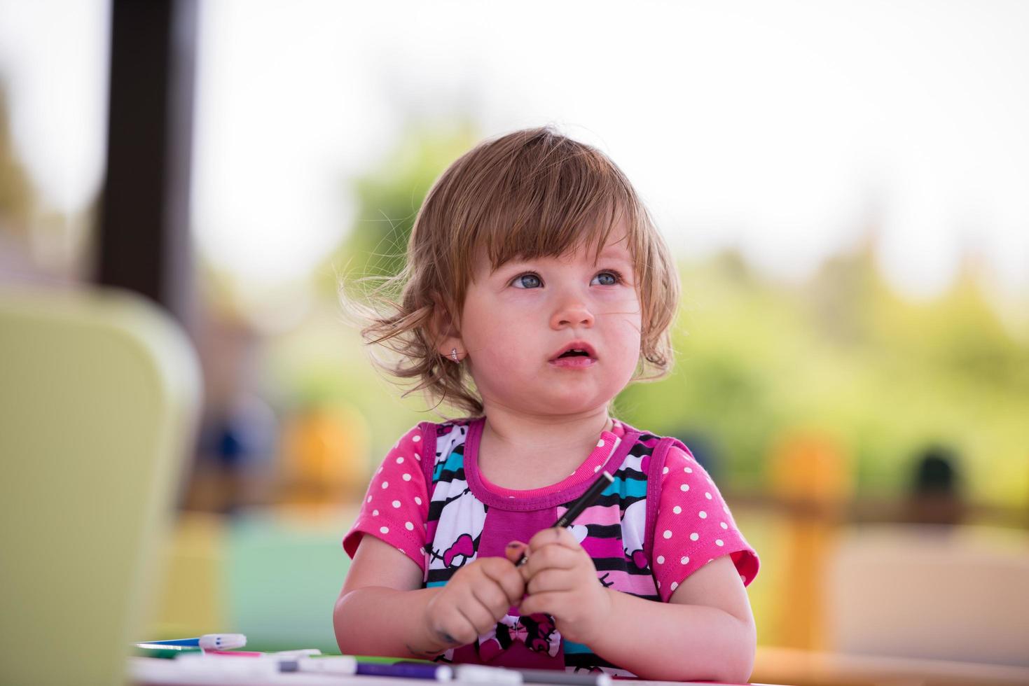 little girl drawing a colorful pictures photo