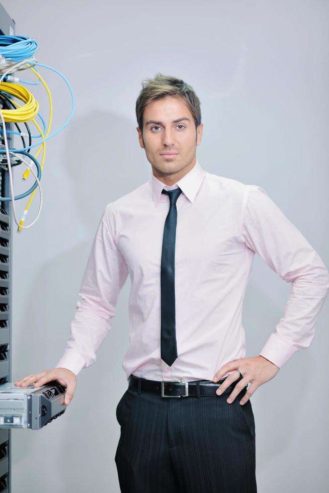 young it engineer in datacenter server room photo