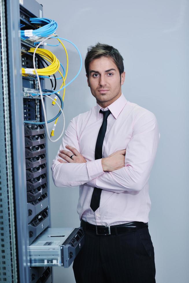 young it engineer in datacenter server room photo