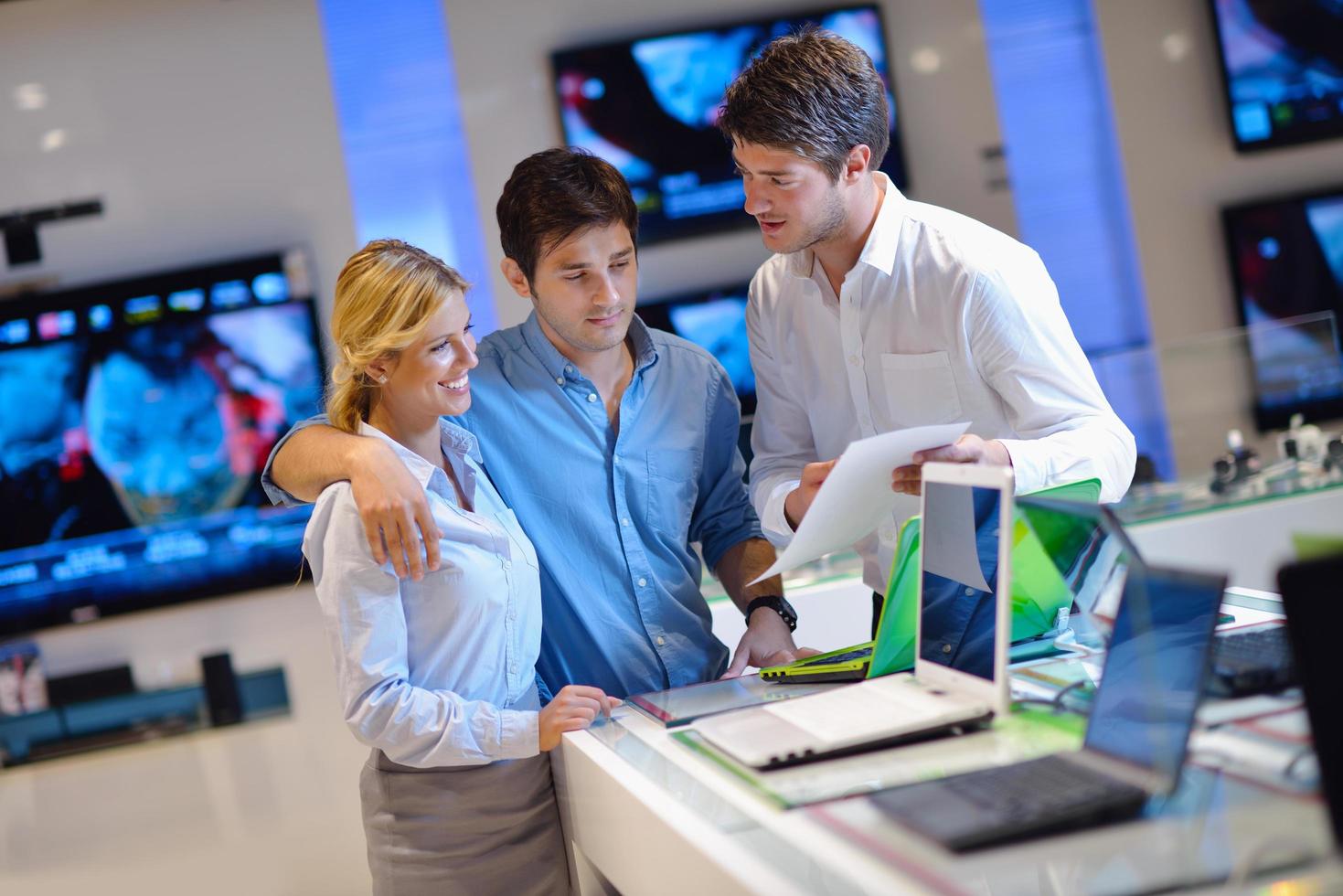 People in electronics store photo