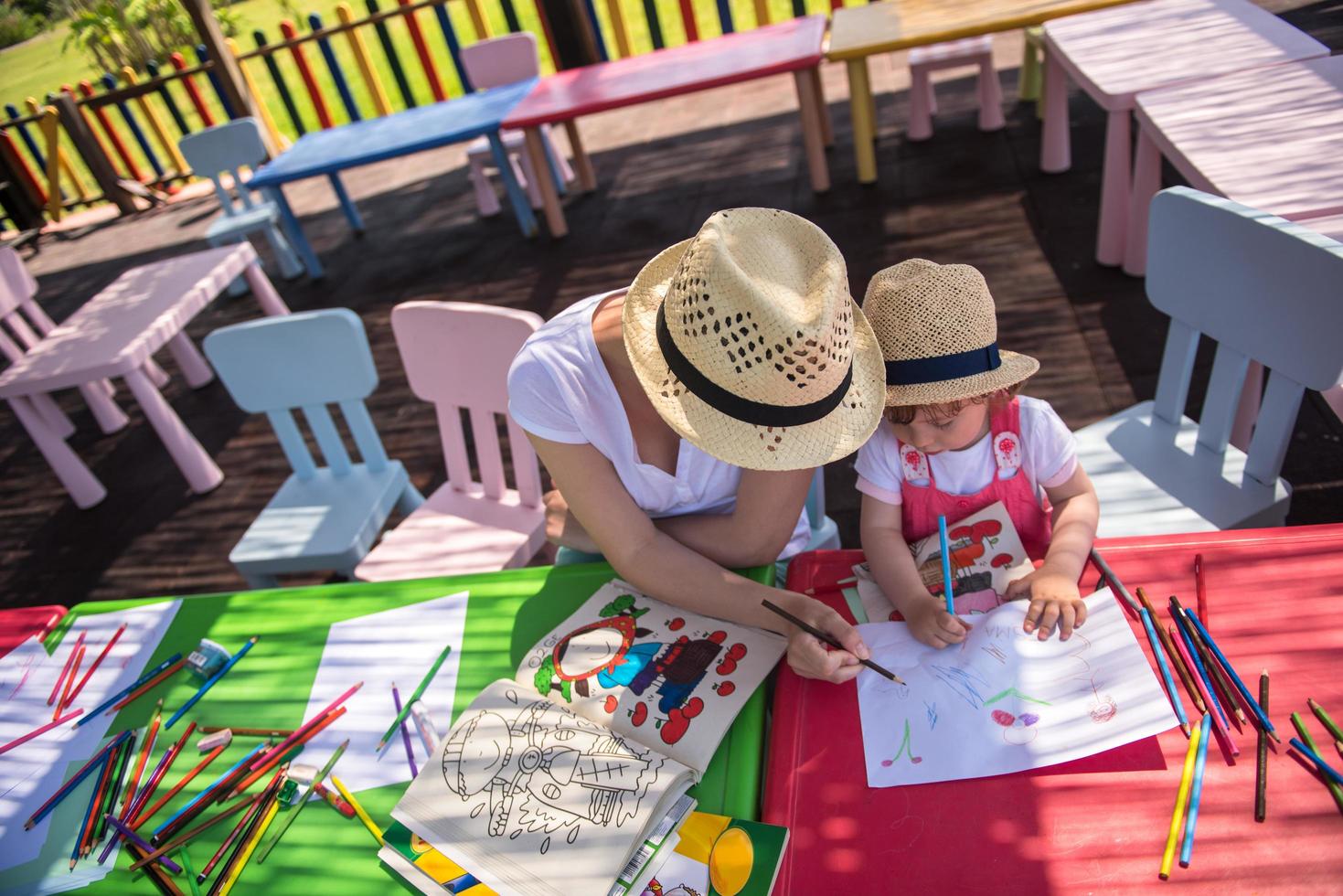 mom and little daughter drawing a colorful pictures photo