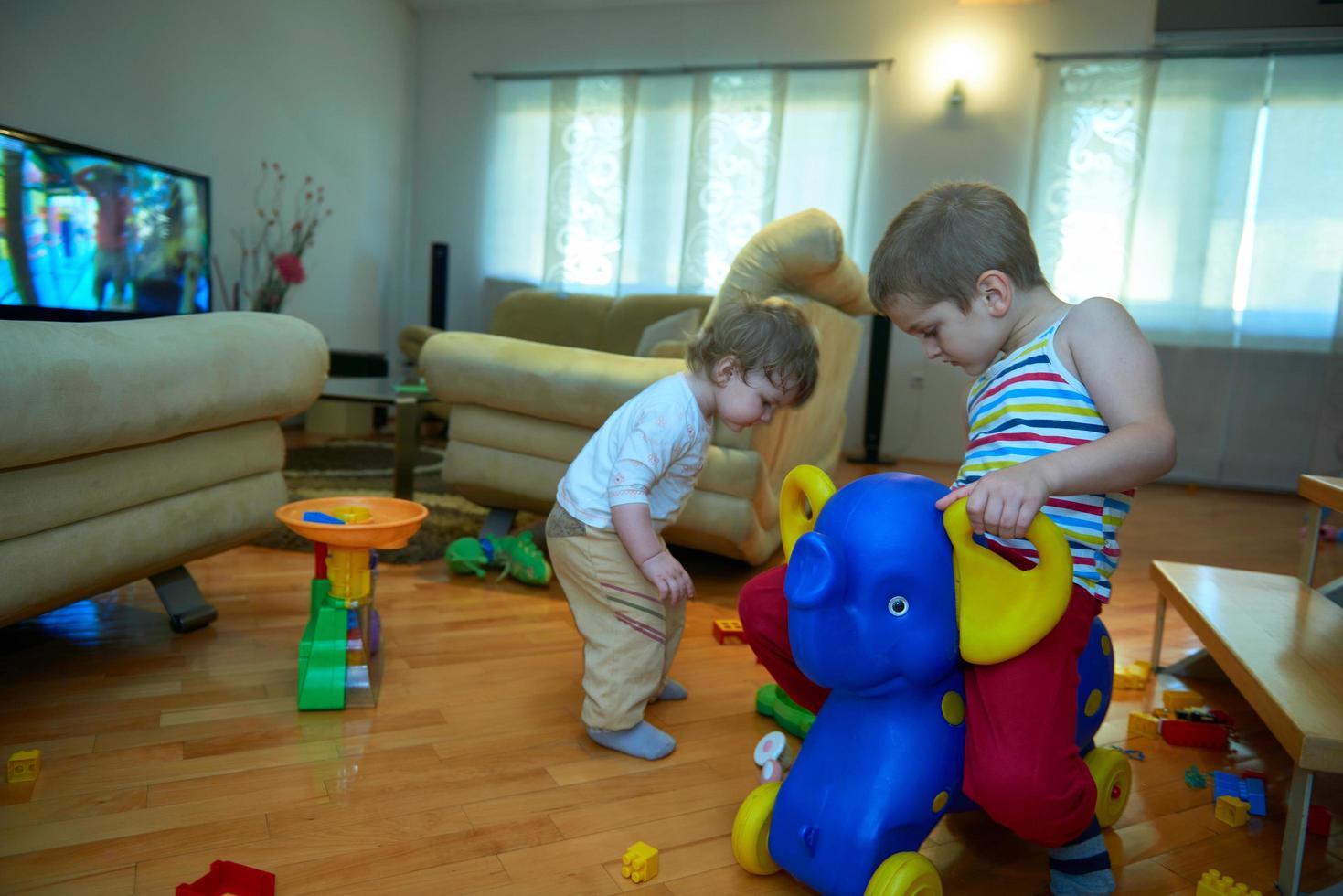 Little child playing  with sister at home photo