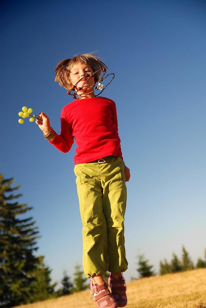 happy child jumping in nature photo