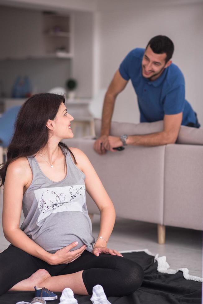 pregnant couple checking a list of things for their unborn baby photo