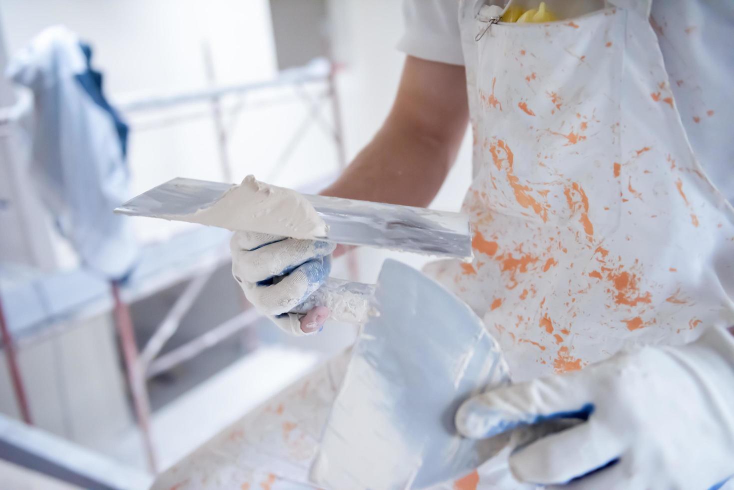 construction worker plastering on gypsum walls photo