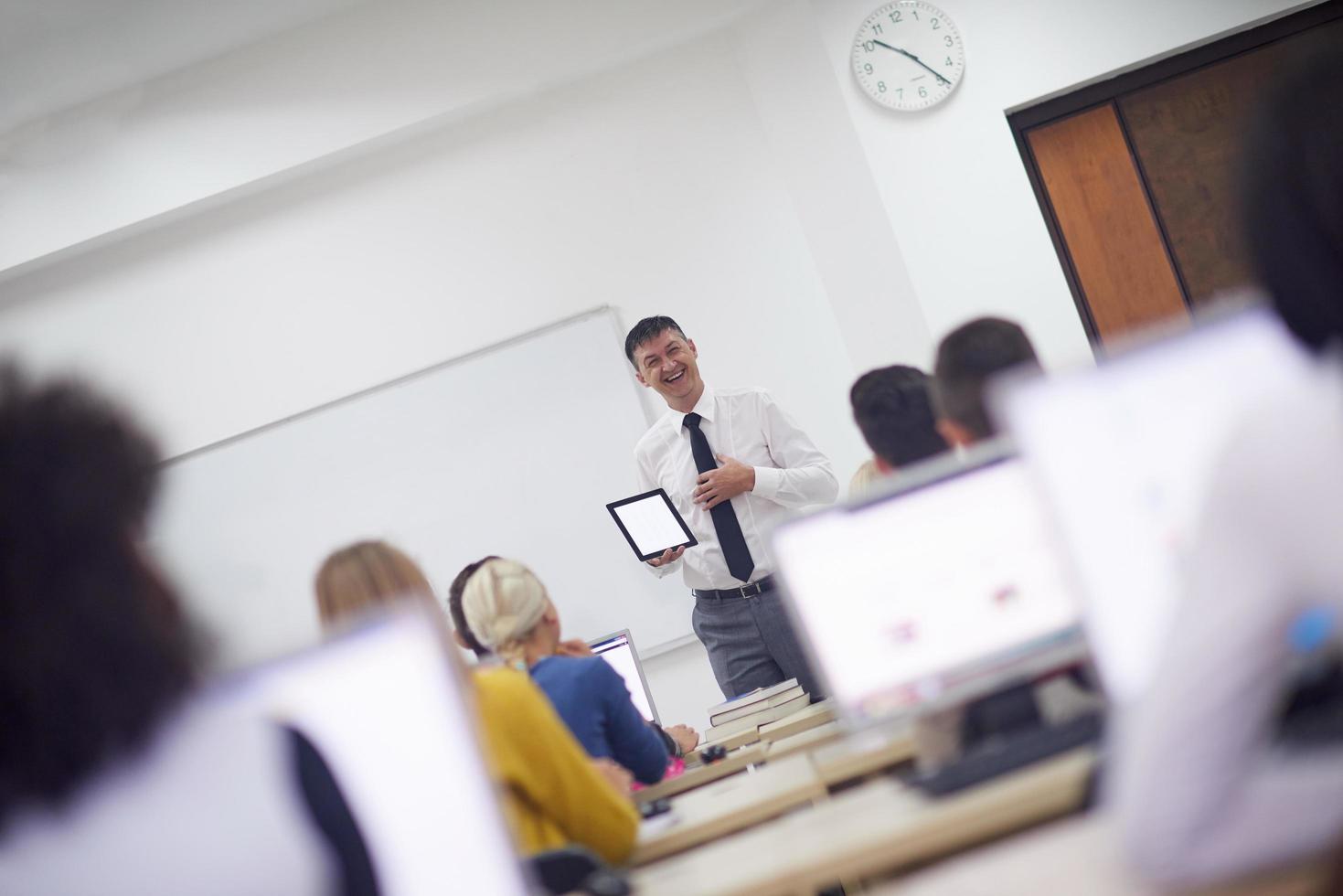 students with teacher  in computer lab classrom photo