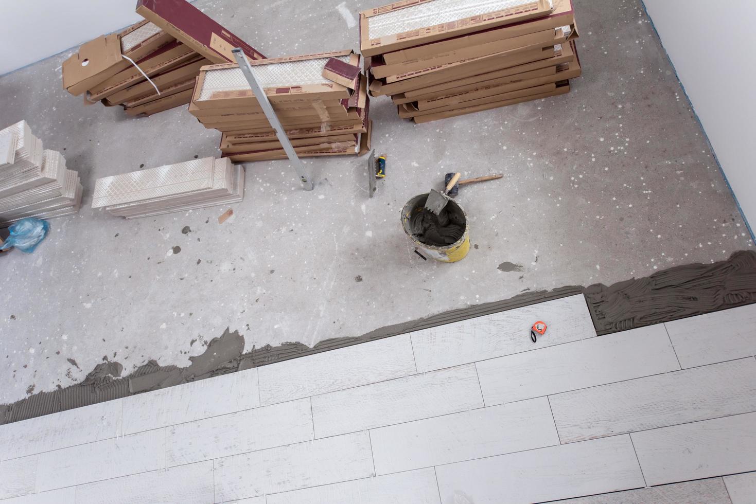 Ceramic wood effect tiles and tools for tiler on the floor photo