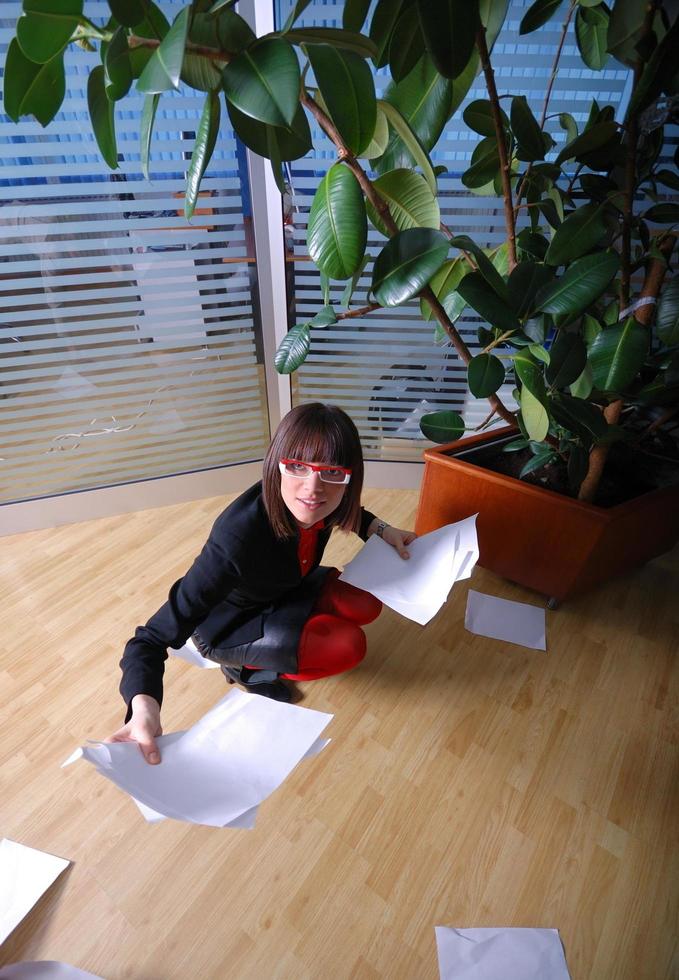 happy businesswoman throwing documents in office photo