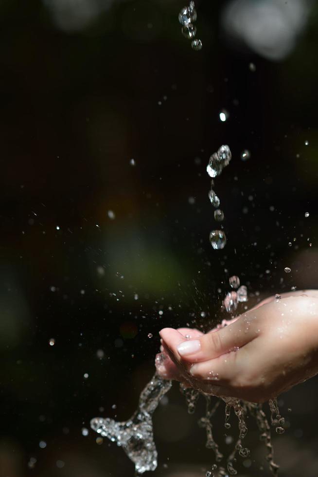 water stream on woman hand photo