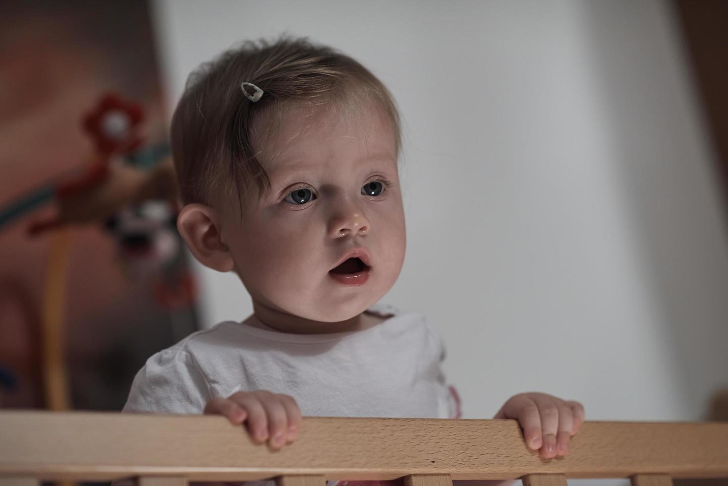 cute  little one year old baby and making first steps in bed photo