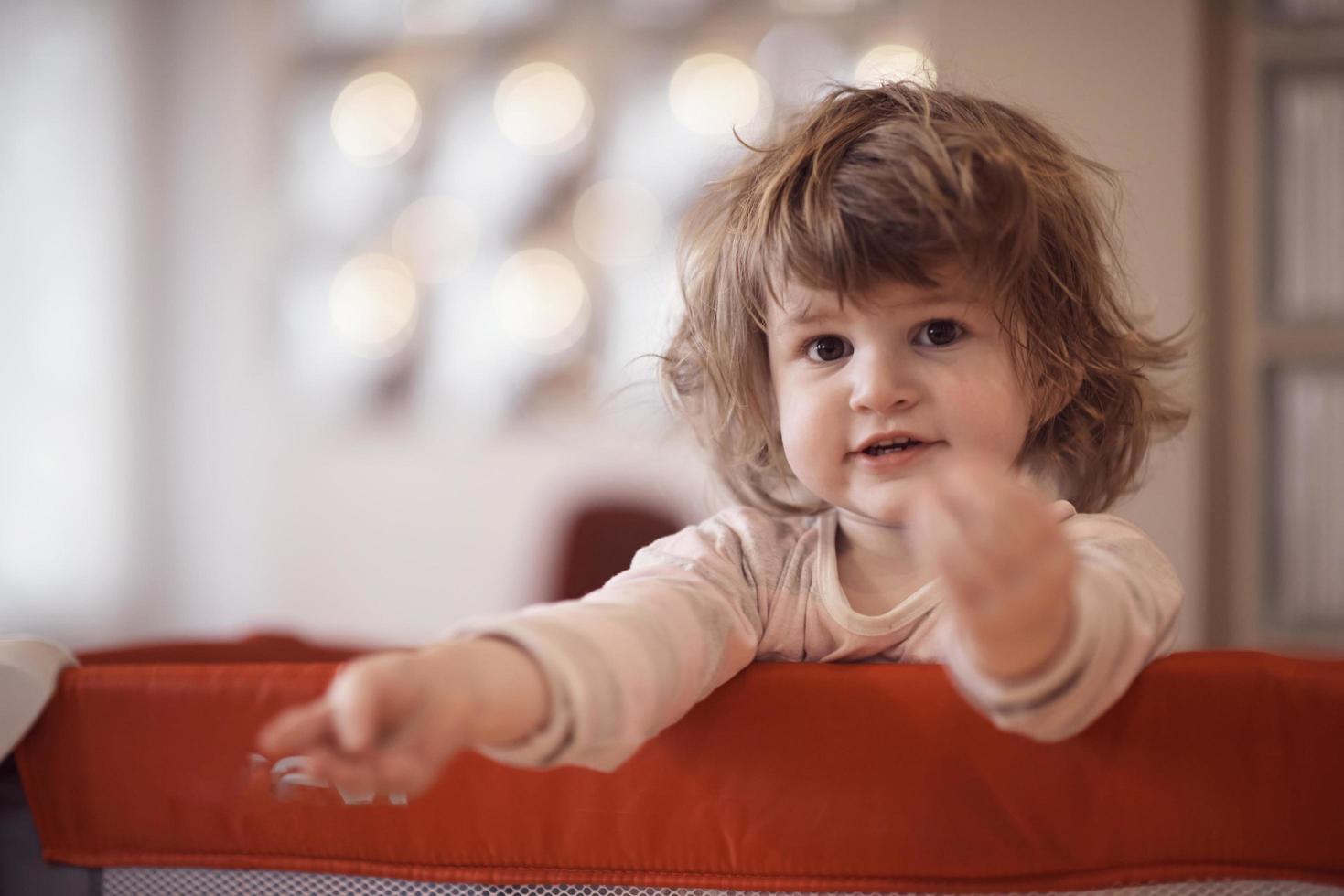 little baby girl with strange hairstyle and curlers photo