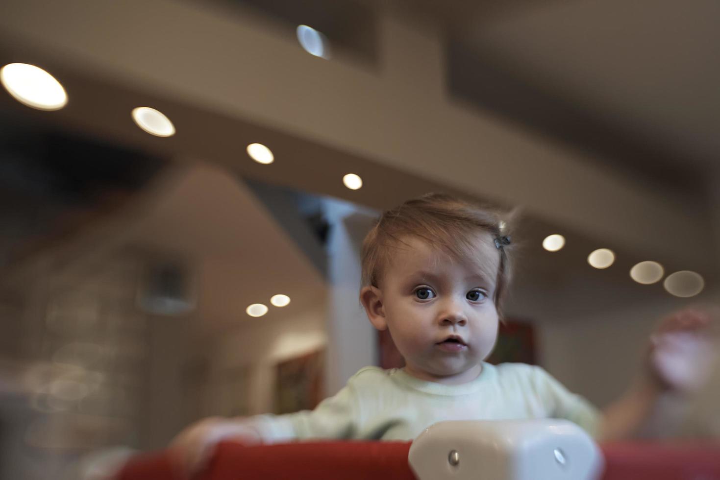 cute  little  baby playing in mobile  bed photo